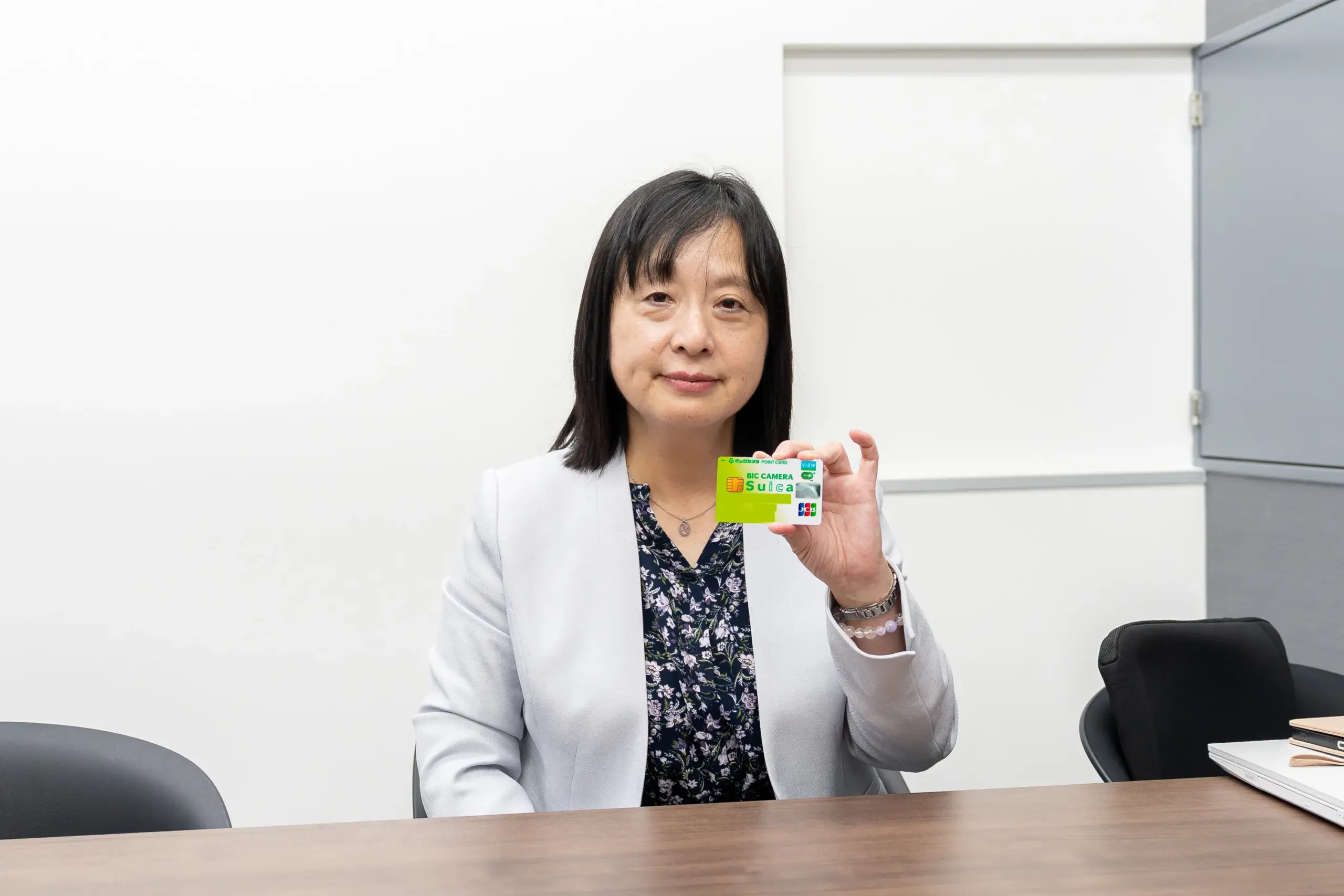 監修者の山内真由美さんが、SuicaチャージにおすすめのクレジットカードとしてビックカメラSuicaカードを持つ様子。
